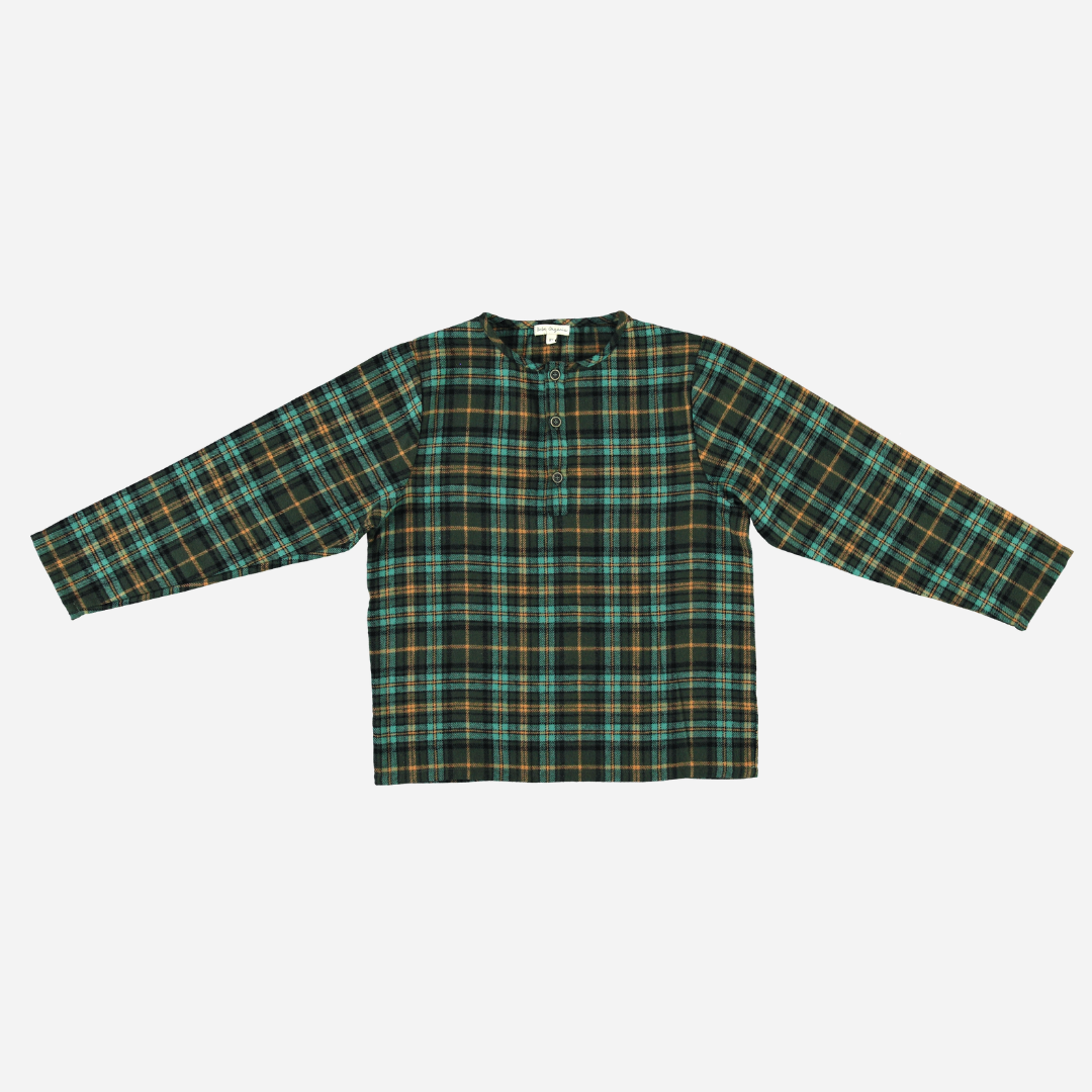 Sold at Bombon Shop, this Bebe Organic baby and toddler boy top features a classic green and gold plaid pattern, crafted from soft organic cotton flannel with long sleeves and a front button detail — a cozy and timeless piece perfect for layering during the fall and winter seasons.