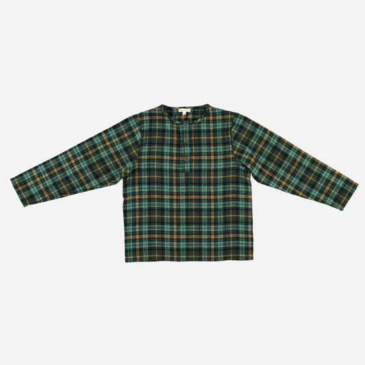 Sold at Bombon Shop, this Bebe Organic baby and toddler boy top features a classic green and gold plaid pattern, crafted from soft organic cotton flannel with long sleeves and a front button detail — a cozy and timeless piece perfect for layering during the fall and winter seasons.