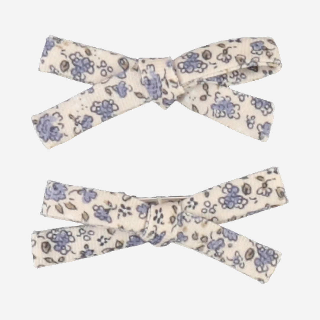 Sold at Bombon Shop, this Bebe Organic set of two baby girl hair clips features dainty blue floral fabric bows crafted from soft organic cotton — a sweet and timeless accessory to complete any outfit with a touch of vintage charm.
