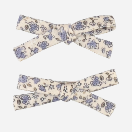 Sold at Bombon Shop, this Bebe Organic set of two baby girl hair clips features dainty blue floral fabric bows crafted from soft organic cotton — a sweet and timeless accessory to complete any outfit with a touch of vintage charm.