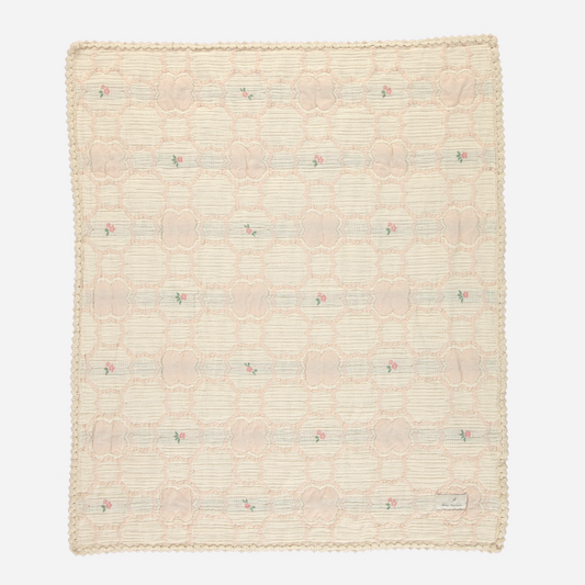 Sold at Bombon Shop, this Bebe Organic baby blanket is crafted from ultra-soft organic cotton in a vintage-inspired woven floral pattern with soft peach and green tones, finished with scalloped crochet trim — a delicate and cozy essential perfect for swaddling, stroller rides, or heirloom-quality nursery decor.
