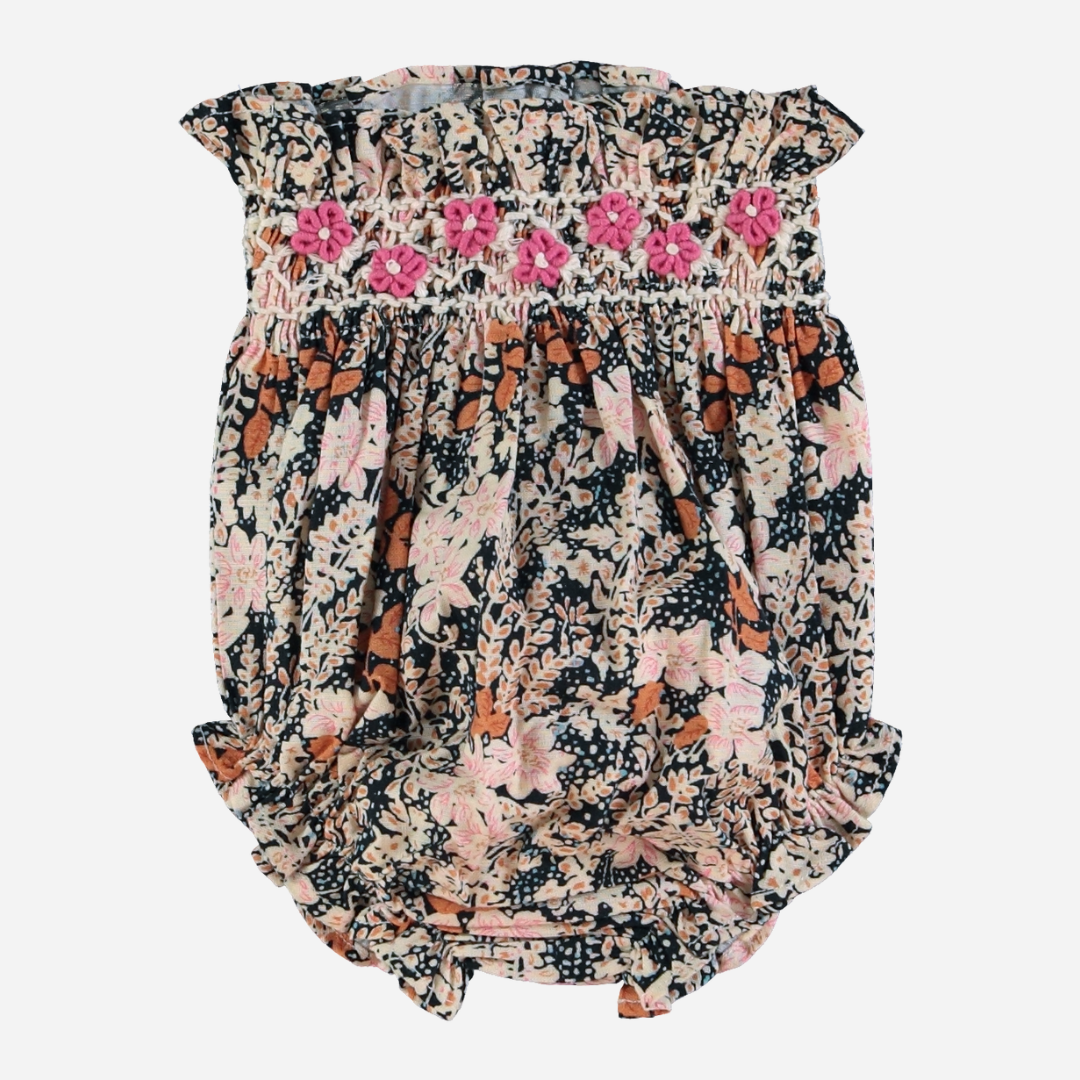 Sold at Bombon Shop, this Bebe Organic baby girl bloomer is crafted from soft organic cotton in a vintage-inspired floral print, featuring hand-smocked pink embroidery, delicate ruffle trims, and an elastic waistband — pair with the matching blouse for a timeless and charming coordinated outfit.