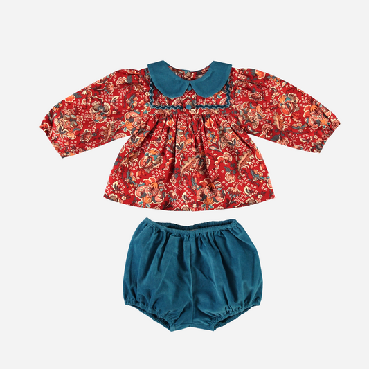 Sold at Bombon Shop, this Bebe Organic baby girl outfit features a floral print top in rich red tones with a contrasting teal Peter Pan collar and long sleeves, paired with coordinating teal corduroy bloomers — a beautifully crafted, vintage-inspired set made from soft organic cotton, perfect for fall and winter wardrobes.