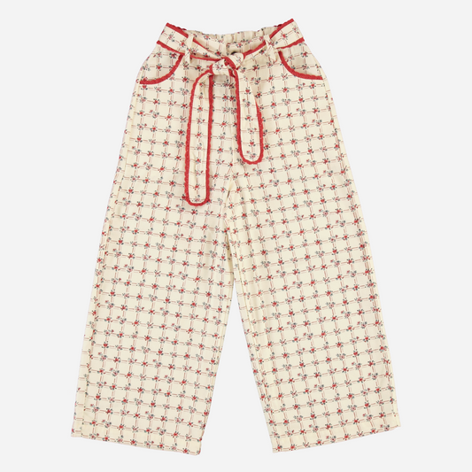 Sold at Bombon Shop, these Bebe Organic wool pants for baby and toddler girls feature a charming cream and red checkered pattern, soft organic wool fabric, a wide-leg silhouette, contrast red piping, and an adjustable drawstring waist — a cozy and stylish piece perfect for cold-weather layering and European-inspired outfits.