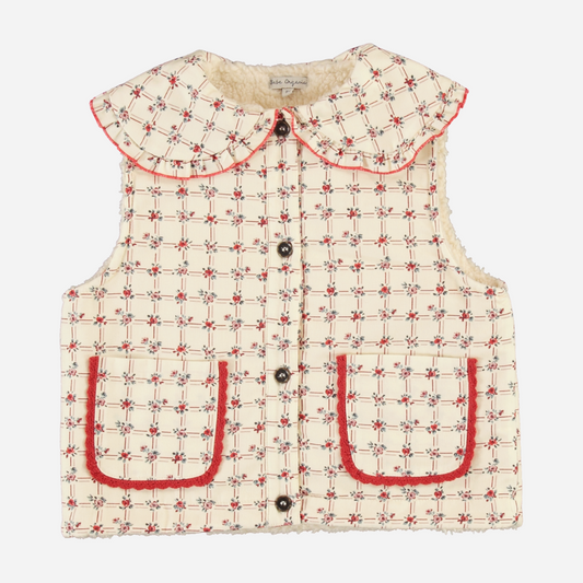 Sold at Bombon Shop, this Bebe Organic baby and toddler vest features a vintage-inspired checkered pattern in cream and red, crafted from soft wool with a cozy faux shearling lining, front button closure, scalloped Peter Pan collar, and patch pockets — a stylish and warm layering piece for fall and winter.