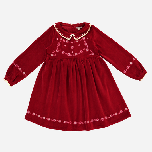 Sold at Bombon Shop, this Bebe Organic velvet dress for baby and toddler girls features a rich red hue, delicate floral embroidery, a scalloped ivory collar, and long sleeves — a timeless holiday dress perfect for festive gatherings and special moments.