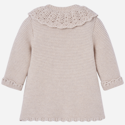 Sold at Bombon shop, designed by Paz Rodriguez. Beige knit coat with openwork scalloped collar and pearlescent buttons down the front.