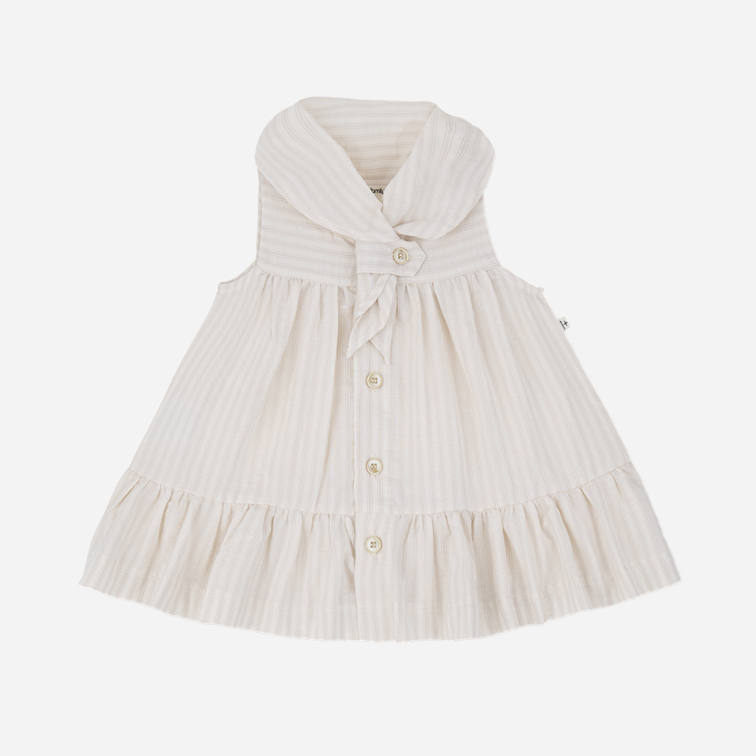 Sold at Bombon Shop, designed by 1+ in the family, beige baby dress with textured vertical stripe cotton fabric and sailor-style collar.