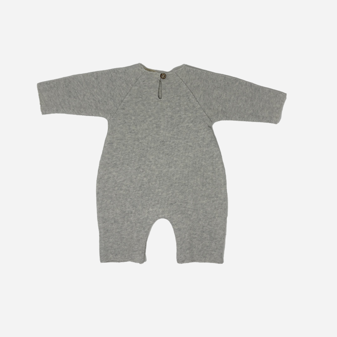 Sold at Bombon shop, designed by Tiny Soul — grey cotton baby romper with “a star is born” embroidery and bottom snap closures. back