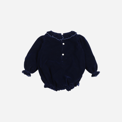 Sold at Bombon shop, this baby girl romper by The New Society is crafted in deep navy velvet with gathered hems, ruffled collar and cuffs, and floral embroidery on the chest—perfect for a festive or special occasion look. back