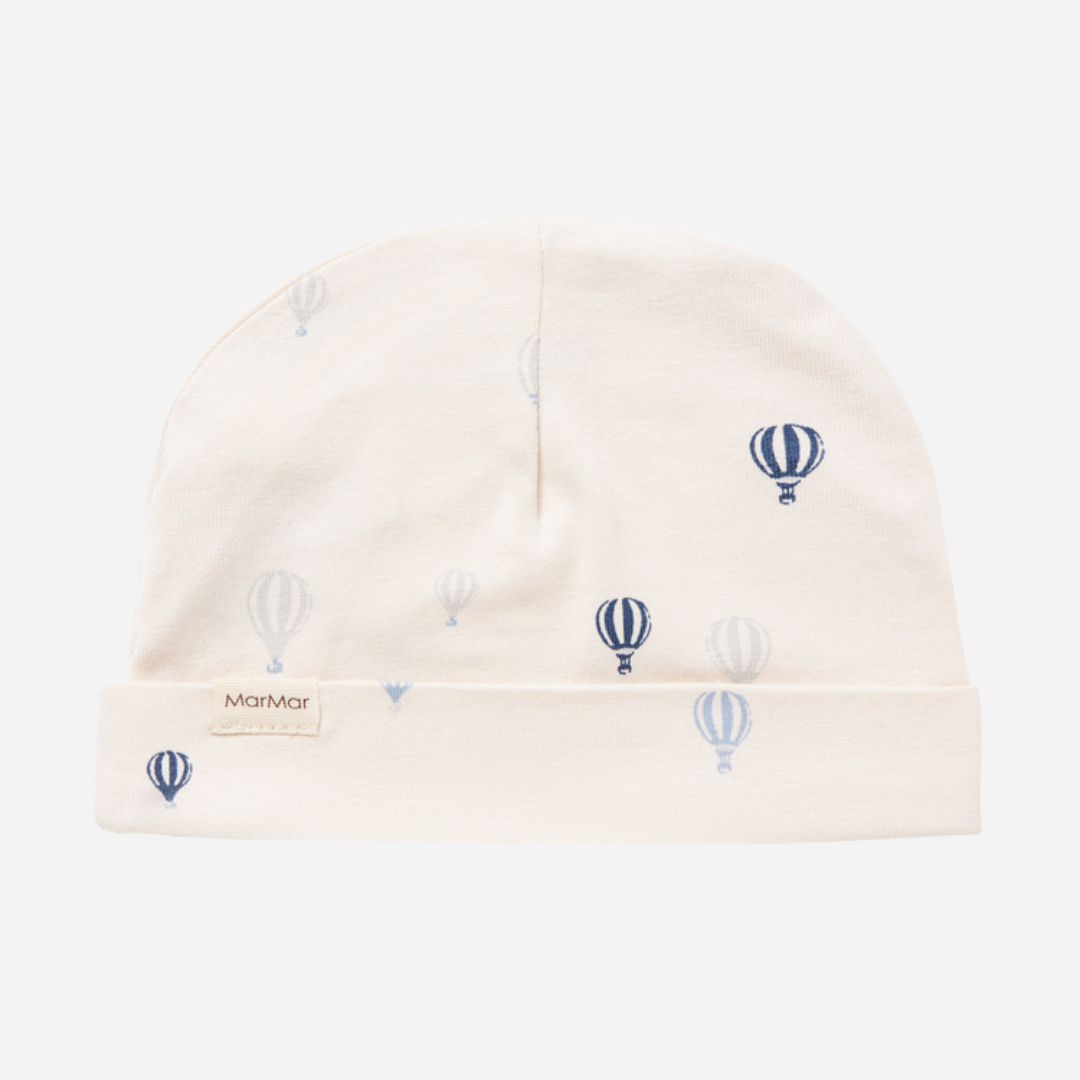 Sold at Bombon shop, designed by MarMar Copenhagen. Cream baby blanket with blue air balloon print, pairs perfectly with the matching air balloon hat and wrap footie.
