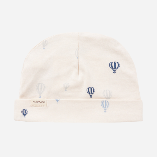 Sold at Bombon shop, designed by MarMar Copenhagen. Cream baby blanket with blue air balloon print, pairs perfectly with the matching air balloon hat and wrap footie.