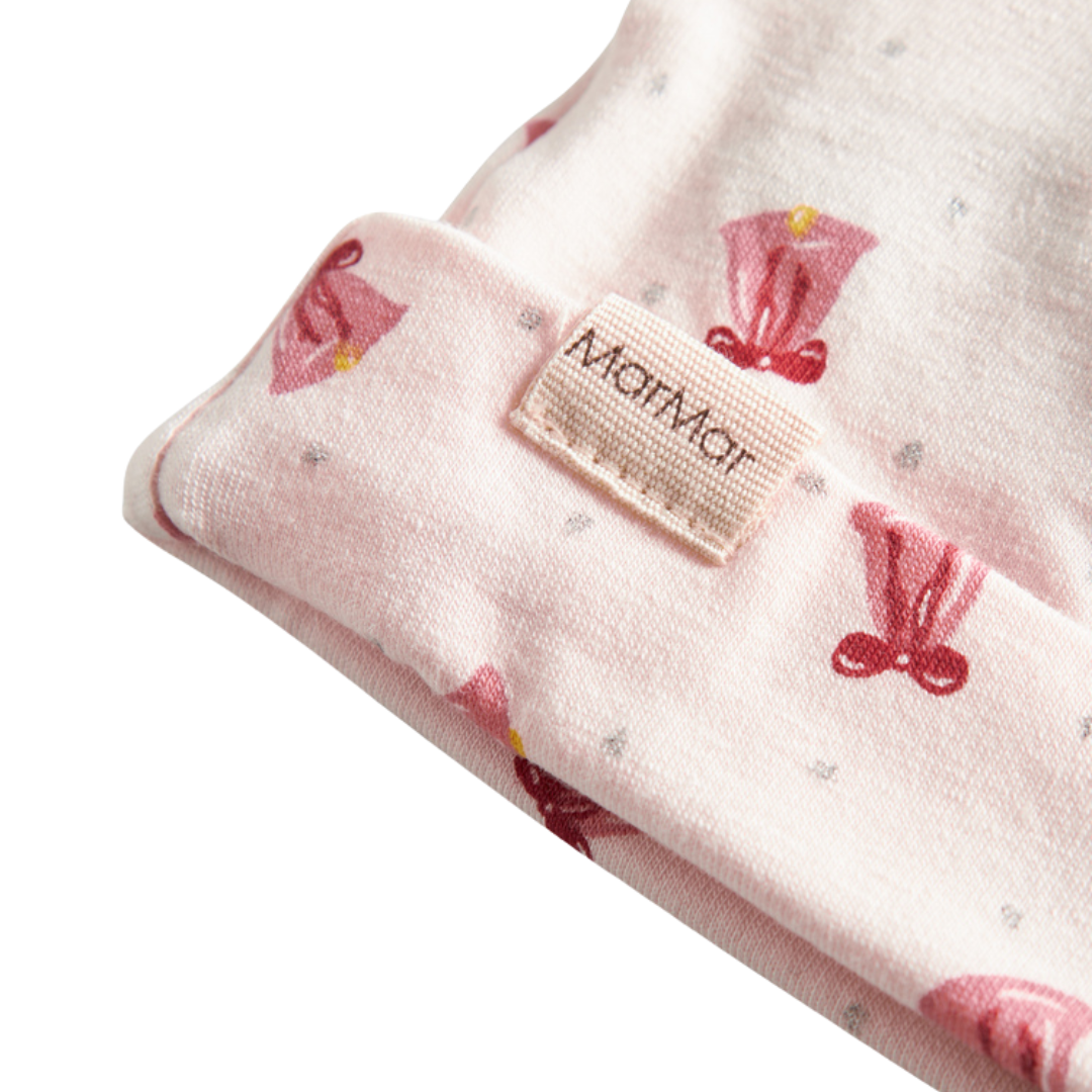 Sold at Bombon shop, designed by MarMar Copenhagen. Blush pink baby hat with pink bell print, pairs perfectly with the matching wrap footie and blanket.