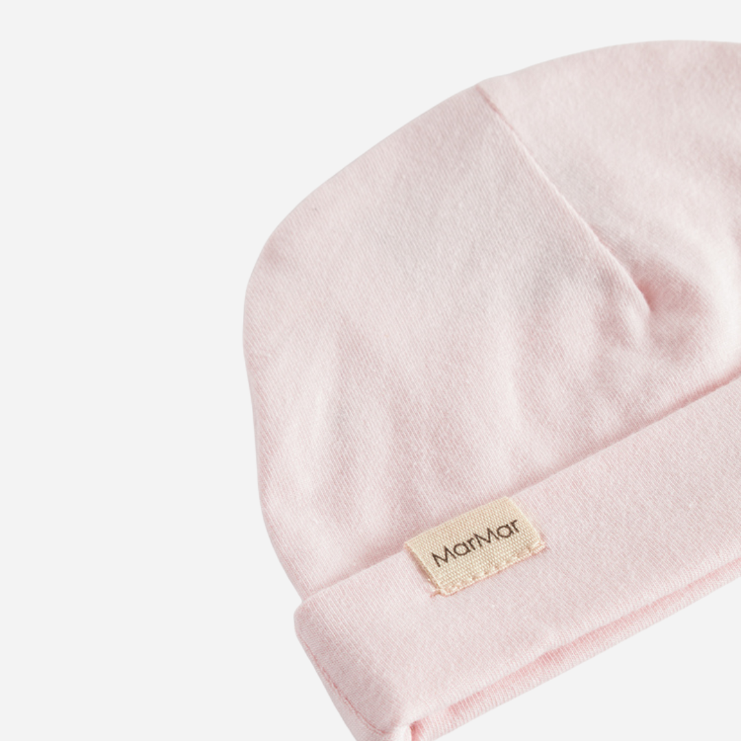 Sold at Bombon shop, designed by MarMar Copenhagen — blush pink organic cotton baby hat with fold-over brim.