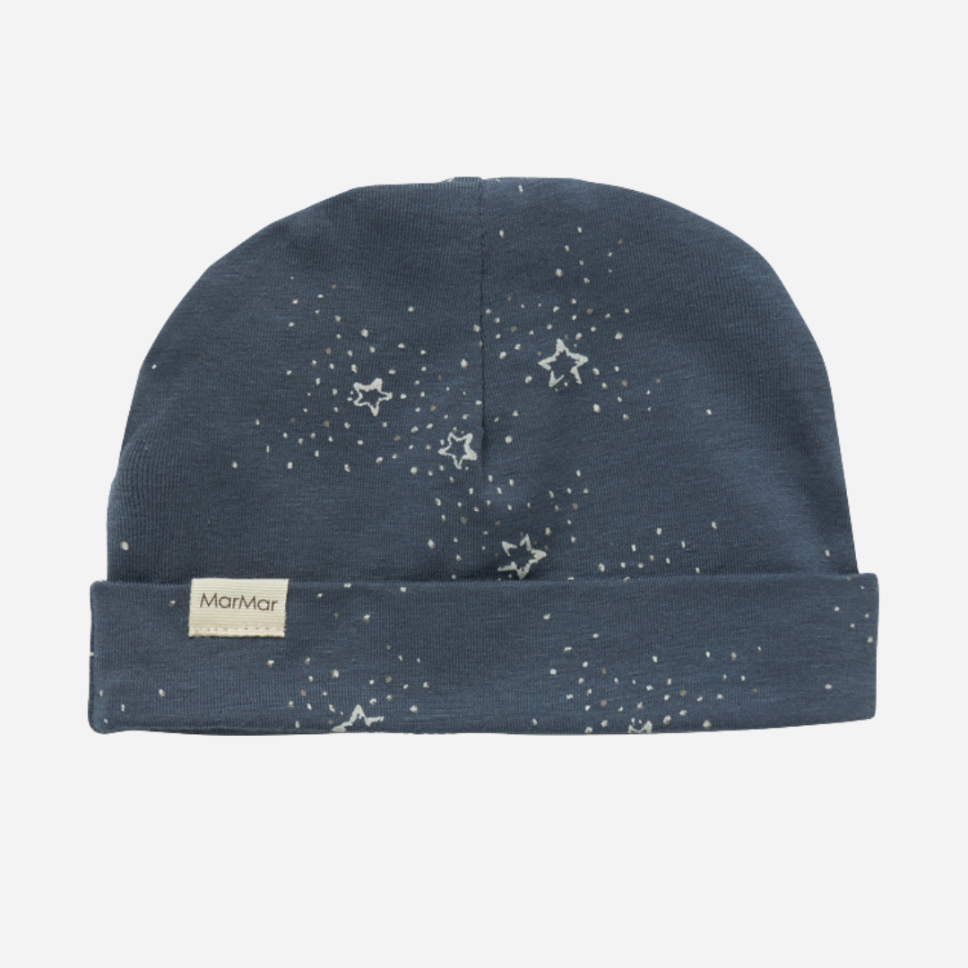 Sold at Bombon shop, designed by MarMar Copenhagen. Midnight blue baby hat with white star print, pairs perfectly with the matching wrap footie and blanket.