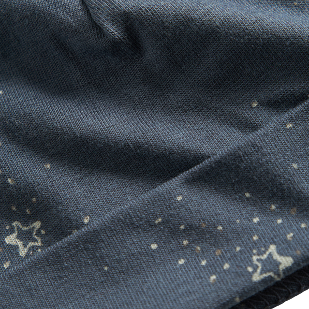 Sold at Bombon shop, designed by MarMar Copenhagen. Midnight blue baby hat with white star print, pairs perfectly with the matching wrap footie and blanket.