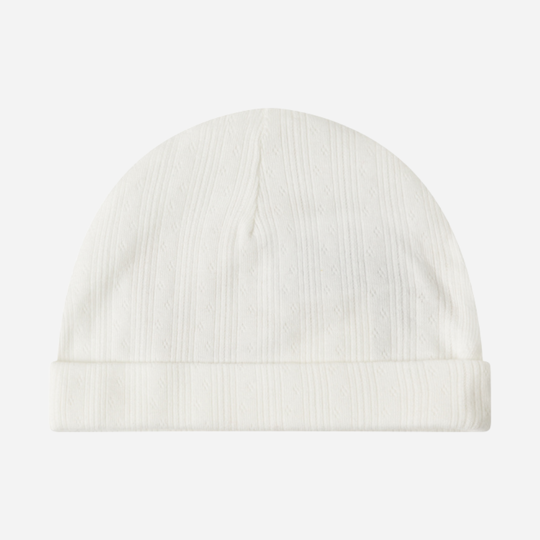 Sold at Bombon shop, designed by MarMar Copenhagen. Cream white ribbed baby hat, pairs perfectly with the matching wrap footie and blanket.