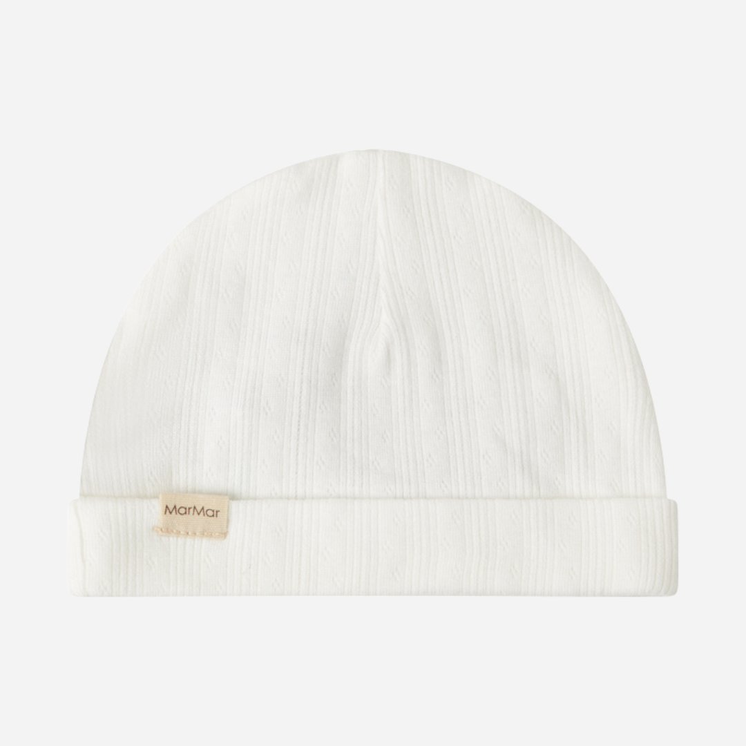 Sold at Bombon shop, designed by MarMar Copenhagen. Cream white ribbed baby hat, pairs perfectly with the matching wrap footie and blanket.