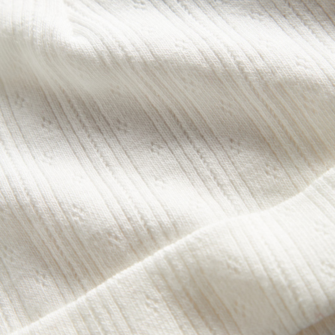 Sold at Bombon shop, designed by MarMar Copenhagen. Cream white ribbed baby hat, pairs perfectly with the matching wrap footie and blanket.