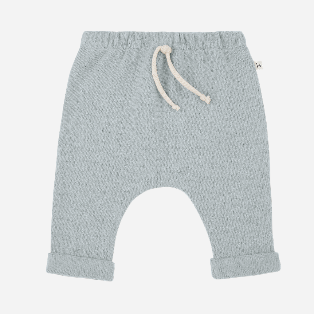 Sold at Bombon shop, designed by 1+ in the family — baby pants in pale blue nuvola knit with rolled hems and natural drawstring waist. front