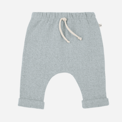 Sold at Bombon shop, designed by 1+ in the family — baby pants in pale blue nuvola knit with rolled hems and natural drawstring waist. front