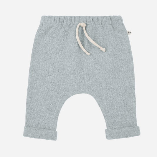 Sold at Bombon shop, designed by 1+ in the family — baby pants in pale blue nuvola knit with rolled hems and natural drawstring waist. front