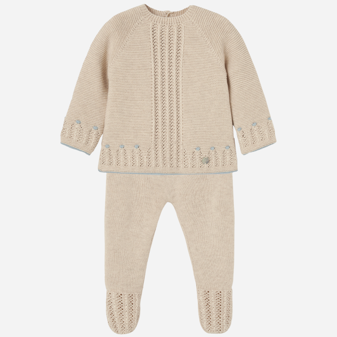 Sold at Bombon shop, designed by Paz Rodriguez. Beige baby knit set for boys with blue accents and footed pants, featuring openwork detail on the top.