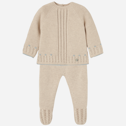 Sold at Bombon shop, designed by Paz Rodriguez. Beige baby knit set for boys with blue accents and footed pants, featuring openwork detail on the top.
