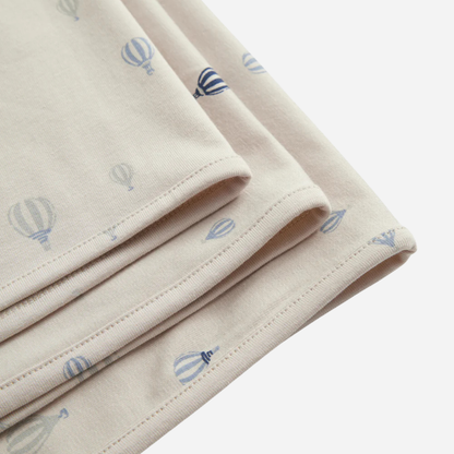 Sold at Bombon shop, designed by MarMar Copenhagen. Cream wrap footie with blue air balloon print, pairs perfectly with the matching air balloon hat and blanket.
