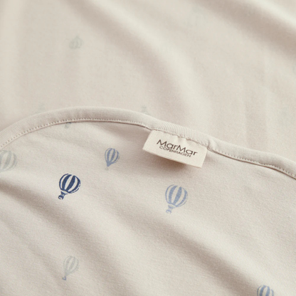 Sold at Bombon shop, designed by MarMar Copenhagen. Cream wrap footie with blue air balloon print, pairs perfectly with the matching air balloon hat and blanket.