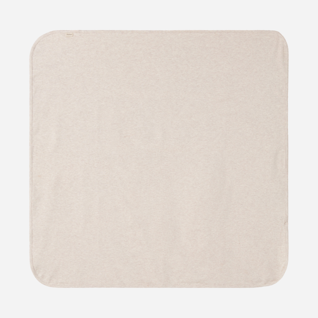 Sold at Bombon shop, designed by MarMar Copenhagen — beige organic cotton baby blanket with scalloped edge.
