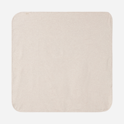 Sold at Bombon shop, designed by MarMar Copenhagen — beige organic cotton baby blanket with scalloped edge.