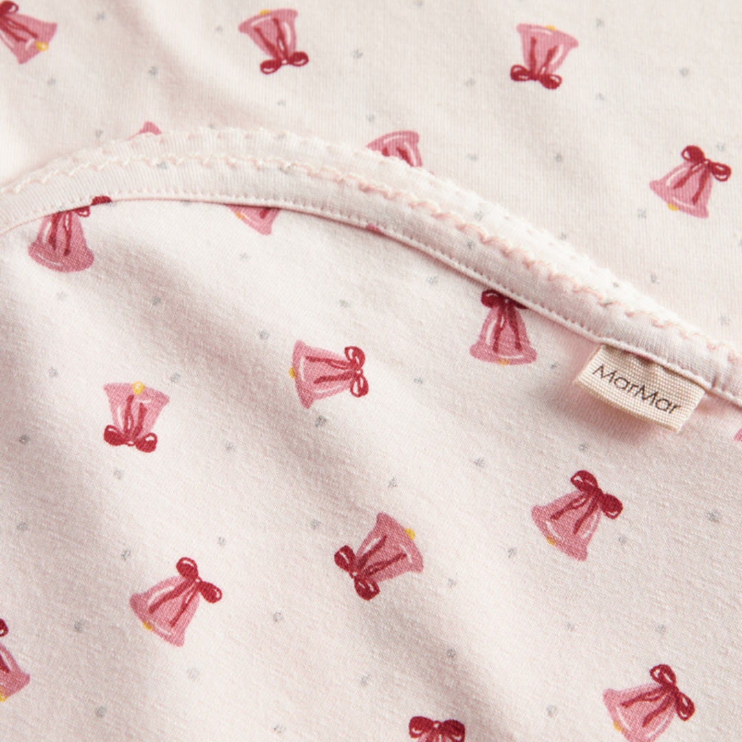 Sold at Bombon shop, designed by MarMar Copenhagen. Blush pink baby blanket with pink bell print, pairs perfectly with the matching wrap footie and hat.