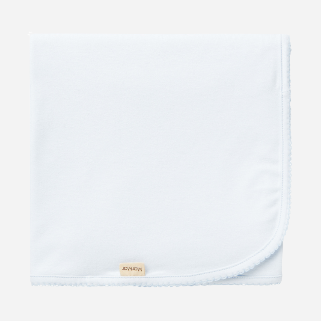 Sold at Bombon shop, designed by MarMar Copenhagen — powder blue organic cotton baby blanket with scalloped edge.