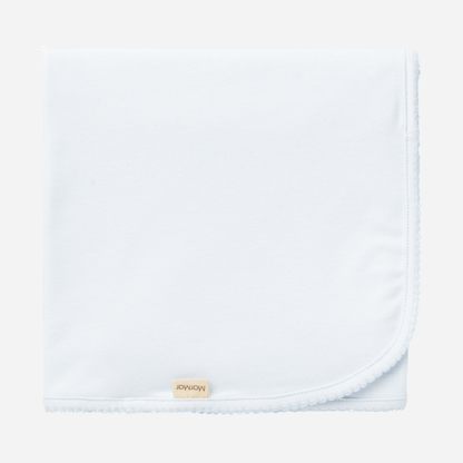Sold at Bombon shop, designed by MarMar Copenhagen — powder blue organic cotton baby blanket with scalloped edge.