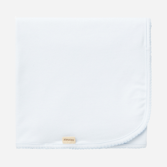 Sold at Bombon shop, designed by MarMar Copenhagen — powder blue organic cotton baby blanket with scalloped edge.