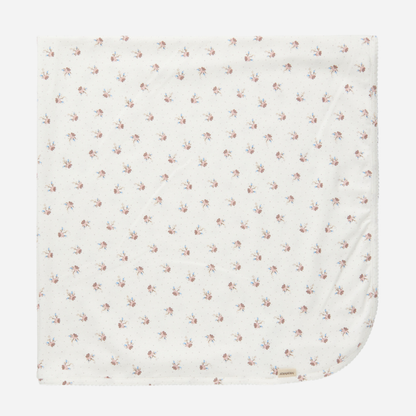 Sold at Bombon shop, designed by MarMar Copenhagen — white organic cotton baby blanket with floral print, part of a matching set.