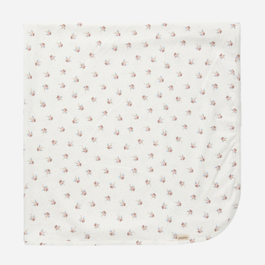 Sold at Bombon shop, designed by MarMar Copenhagen — white organic cotton baby blanket with floral print, part of a matching set.