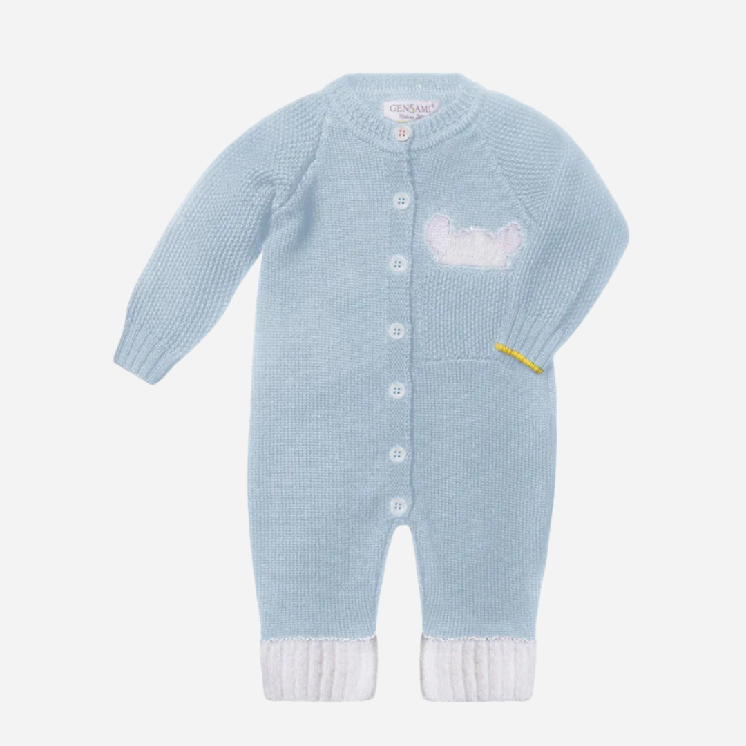 Sold at Bombon and designed by Gensami, a light blue knit baby romper with front buttons, white ribbed cuffs, a small bear motif on the chest pocket, and a yellow trim on the sleeve.