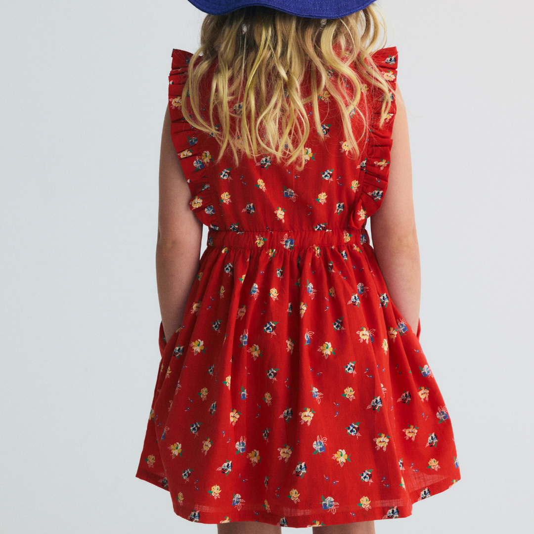 sold at Bombon, designed by The New Society red amapola floral girls dress in 100% organic cotton with sleeveless silhouette matching sibling set