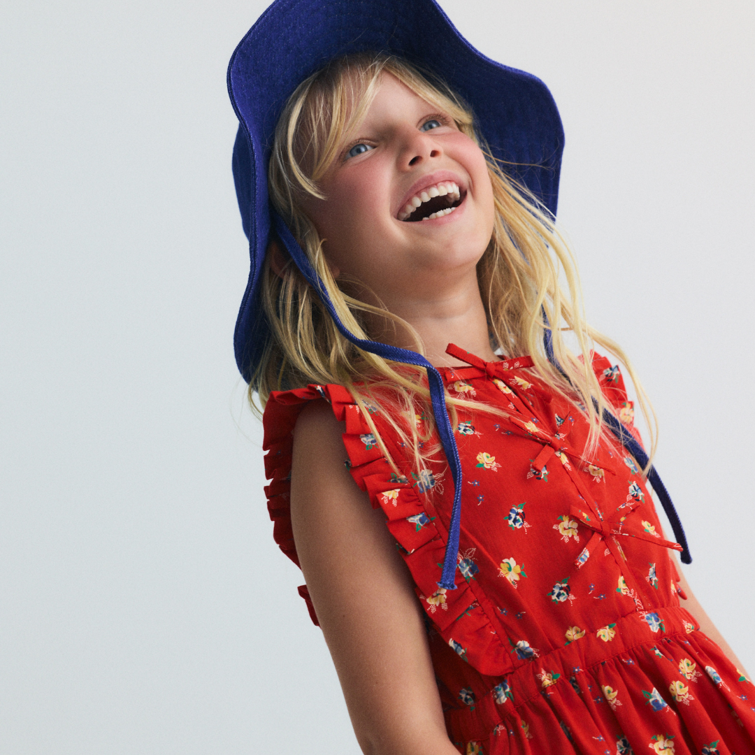 sold at Bombon, designed by The New Society red amapola floral girls dress in 100% organic cotton with sleeveless silhouette matching sibling set