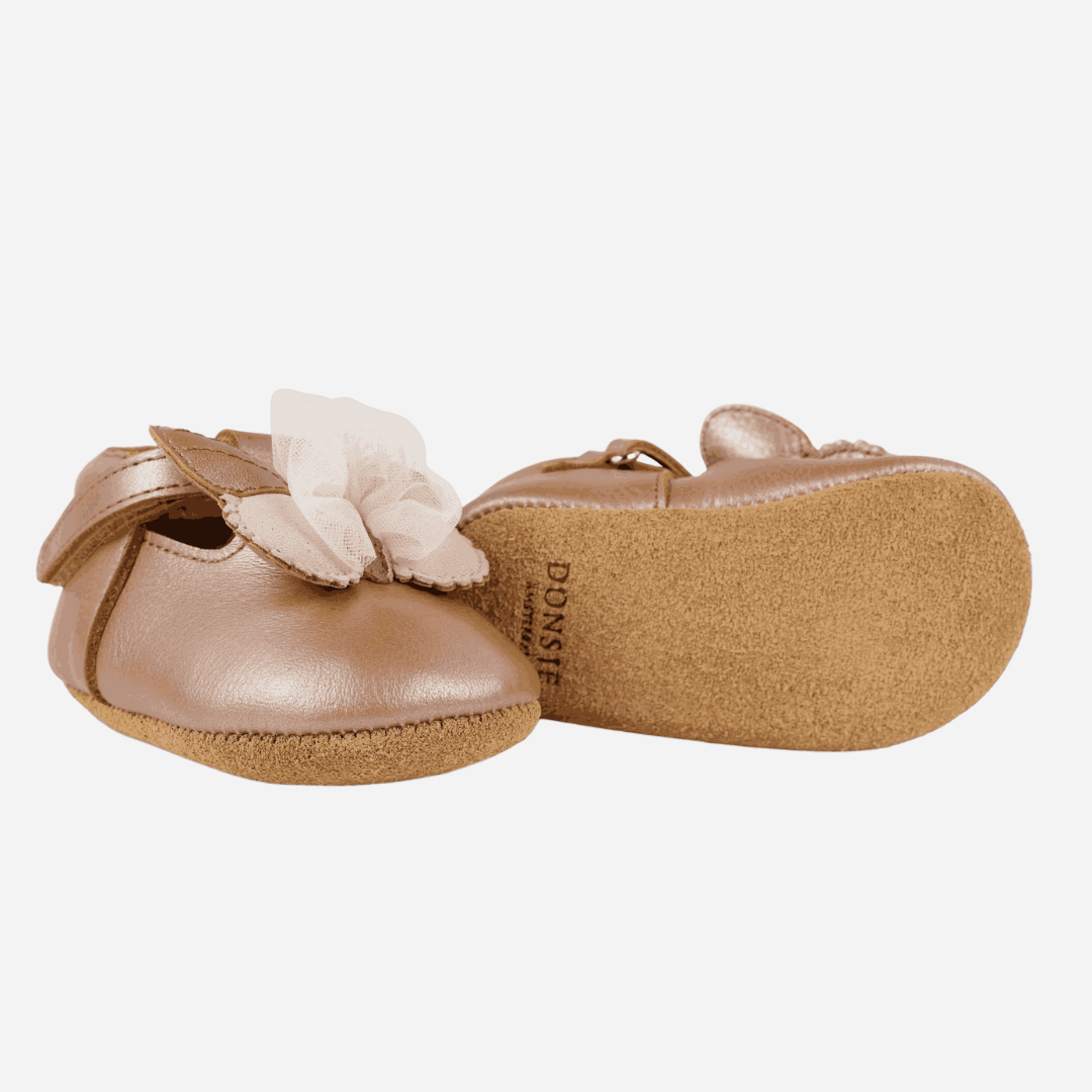 Sold at Bombon shop, designed by Donsje from Amsterdam, these butterfly detail, metallic rose shoes for baby girls are perfect to complete any outfit and keep the little feet comfortable all day. Bottom view