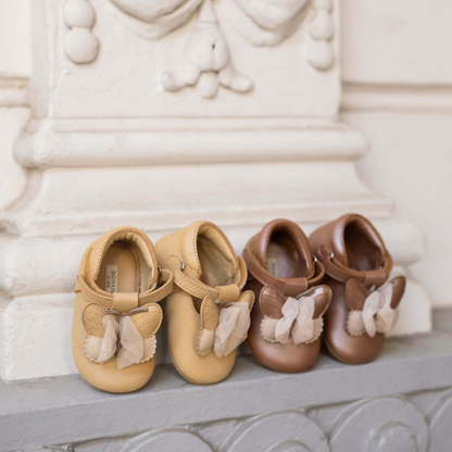 Sold at Bombon shop, designed by Donsje from Amsterdam, these butterfly detail, metallic rose shoes for baby girls are perfect to complete any outfit and keep the little feet comfortable all day. lifestyle view