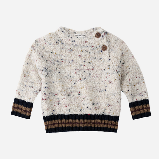 Sold at Bombon shop, designed by 1+ in the family — speckled knit baby sweater with contrast ribbed cuffs and buttoned shoulder, in cream with navy and brown accents. front