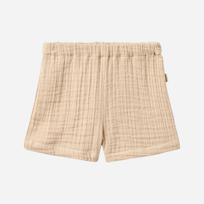 Sold at Bombon Shop, designed by Wheat, warm sand organic cotton kids shorts with subtle vertical stripes and elastic waistband.
