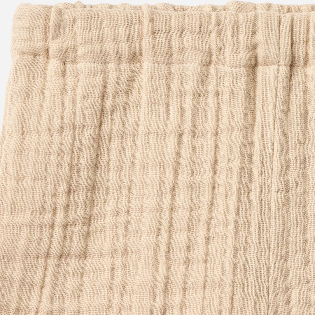 Sold at Bombon Shop, designed by Wheat, warm sand organic cotton kids shorts with subtle vertical stripes and elastic waistband.