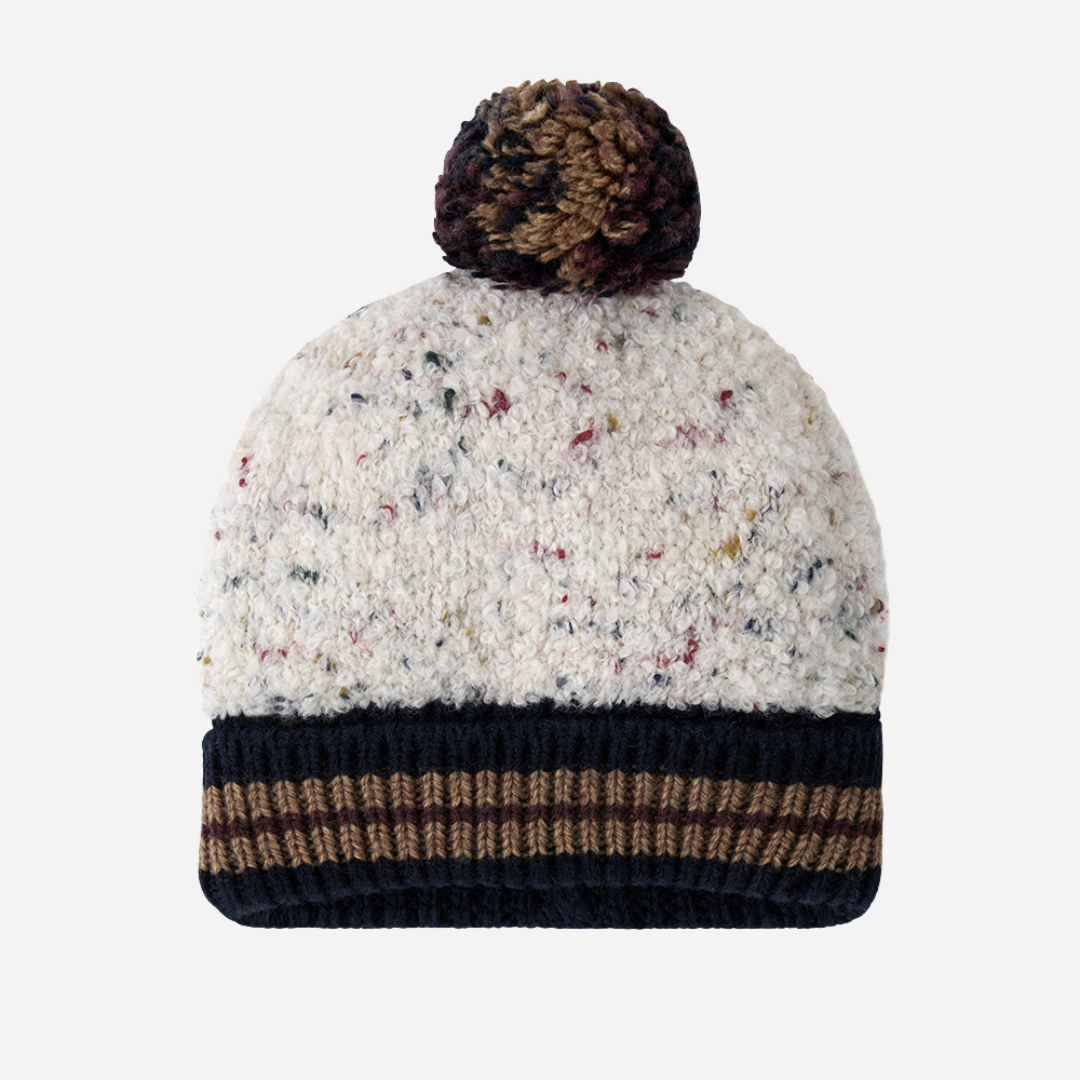 Sold at Bombon shop, designed by 1+ in the family — speckled knit baby beanie with ribbed navy and chestnut brim and multicolored pom-pom on top. front