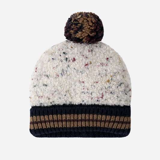 Sold at Bombon shop, designed by 1+ in the family — speckled knit baby beanie with ribbed navy and chestnut brim and multicolored pom-pom on top. front