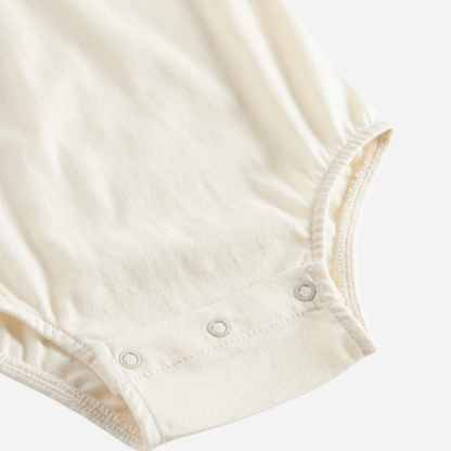 Sold at Bombon shop, designed by MarMar Copenhagen. Cream long-sleeve bodysuit with red embroidered collar, pairs perfectly with the red plaid bloomers and matching red cardigan.