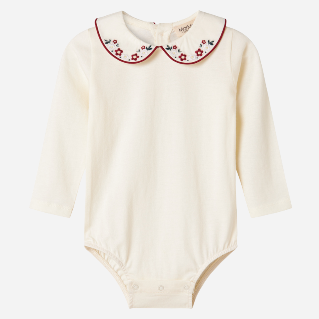 Sold at Bombon shop, designed by MarMar Copenhagen. Cream long-sleeve bodysuit with red embroidered collar, pairs perfectly with the red plaid bloomers and matching red cardigan.